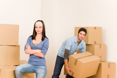 Professional movers protecting household furniture during transit